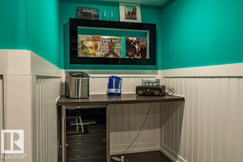 Built-in corner desk with a dark countertop and undercounter beverage refrigeration - 17123 49 Street, Edmonton, AB 