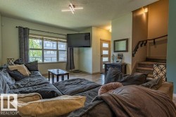 Living area with wood-finish flooring and large window - 