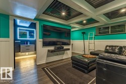 Lower-level living area featuring wood-finish flooring and wainscoting - 