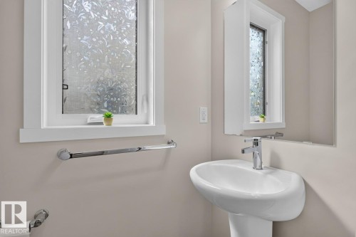Modern pedestal sink with a chrome faucet - 1022 Hearthstone Boulevard, Sherwood Park, AB 