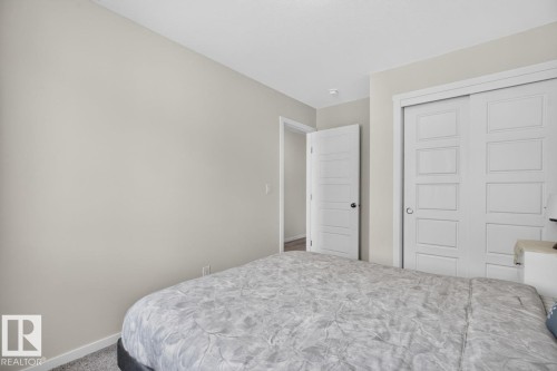 Bedroom featuring light gray walls, white trim, and gray carpet - 1022 Hearthstone Boulevard, Sherwood Park, AB 