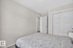 Bedroom featuring light gray walls, white trim, and gray carpet - 