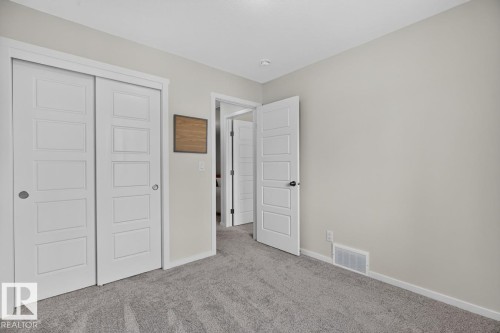 Neutral wall paint with textured gray carpet - 1022 Hearthstone Boulevard, Sherwood Park, AB 