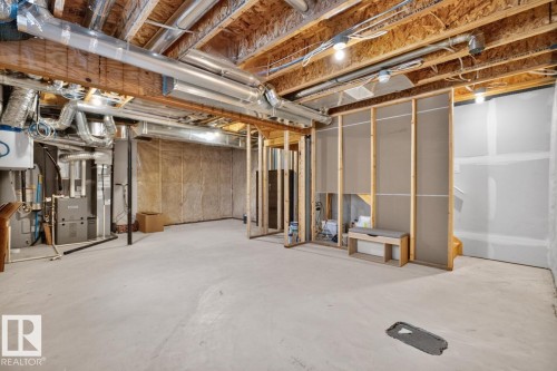 Unfinished lower level offering expansive open space, visible mechanical systems, exposed ceiling joists, framed partition walls, and concrete flooring - 1022 Hearthstone Boulevard, Sherwood Park, AB 