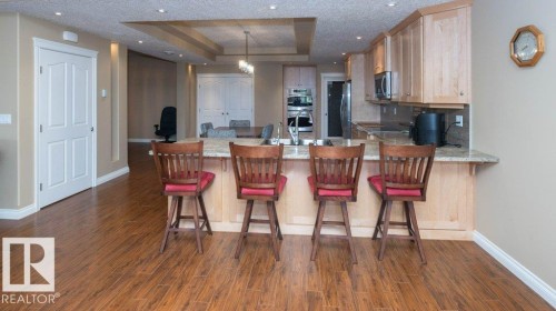 Kitchen featuring a light-toned cabinetry, granite countertops, and an undermount sink - 58505 Rng Rd 260, Rural Westlock County, AB 