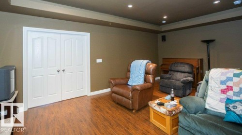 Recessed lighting illuminates wood-finish flooring with white baseboards - 58505 Rng Rd 260, Rural Westlock County, AB 
