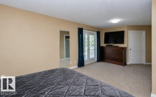 Carpeted interior space featuring neutral wall paint, white trim, and a white six-panel door - 58505 Rng Rd 260, Rural Westlock County, AB 