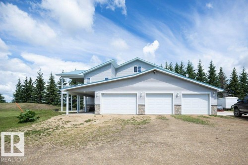 Exterior featuring light grey horizontal siding and a light blue metal roof - 58505 Rng Rd 260, Rural Westlock County, AB 