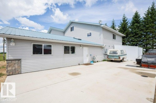 Gray siding exterior with a light blue metal roof - 58505 Rng Rd 260, Rural Westlock County, AB 