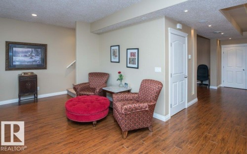 Open living area featuring wood-finish flooring, recessed lighting, and a neutral wall palette - 58505 Rng Rd 260, Rural Westlock County, AB 