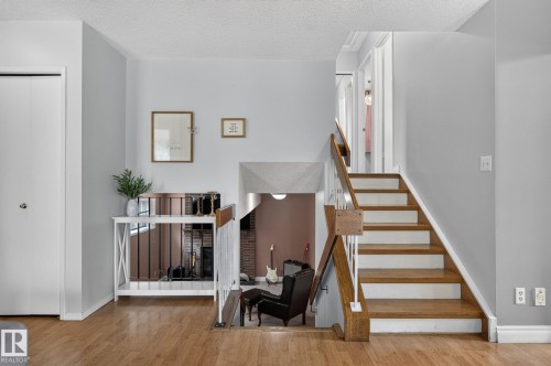 Hardwood flooring extending throughout the main level and staircase - 14612 29 Street Nw, Edmonton, AB 
