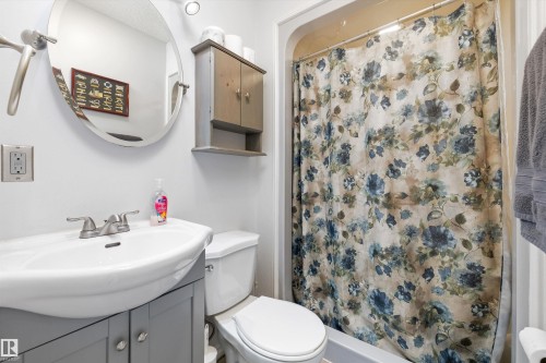 Bathroom featuring a vanity with a white basin sink, polished chrome faucet, and storage cabinetry - 7 53424 Range Road 13, Rural Parkland County, AB 