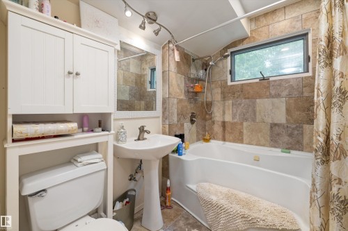 Bathroom featuring a pedestal sink, white toilet, and track lighting - 7 53424 Range Road 13, Rural Parkland County, AB 