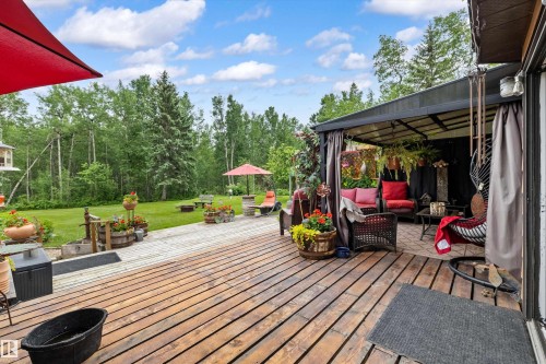 Expansive wood-finish deck with a covered patio area - 7 53424 Range Road 13, Rural Parkland County, AB 