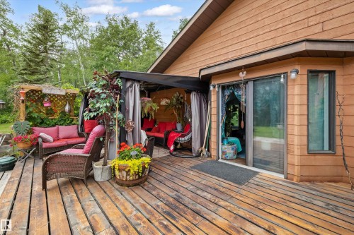 Spacious wood deck with pergola, covered patio area, and sliding glass door access to the interior - 7 53424 Range Road 13, Rural Parkland County, AB 