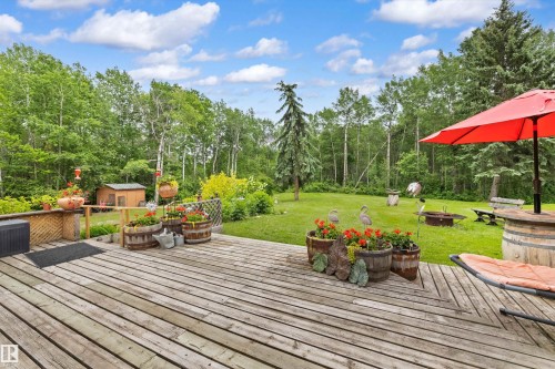 Expansive wood-plank deck overlooking a large grassy area - 7 53424 Range Road 13, Rural Parkland County, AB 