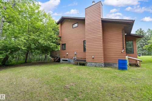 Wood-sided home with a prominent chimney structure - 7 53424 Range Road 13, Rural Parkland County, AB 