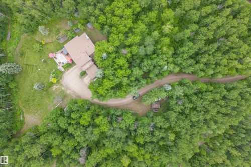 Secluded property featuring a residence with a brown shingle roof, surrounded by extensive mature tree coverage - 7 53424 Range Road 13, Rural Parkland County, AB 
