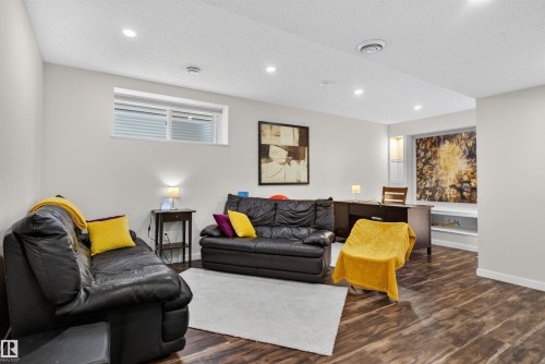 Versatile room featuring rich wood-finish flooring, recessed lighting, and light-toned walls - 6928 22 Avenue, Edmonton, AB 
