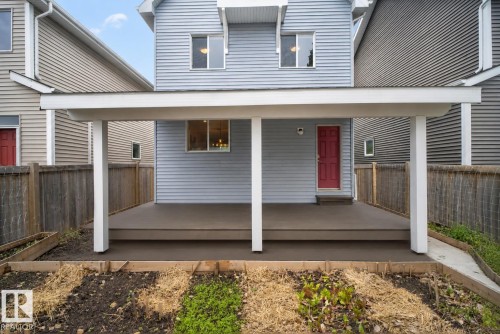 Covered deck with composite flooring and white support columns - 6928 22 Avenue, Edmonton, AB 