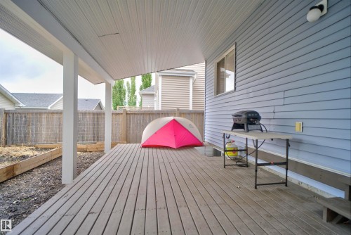 Covered deck featuring wood-finish flooring and a light-toned soffit - 6928 22 Avenue, Edmonton, AB 