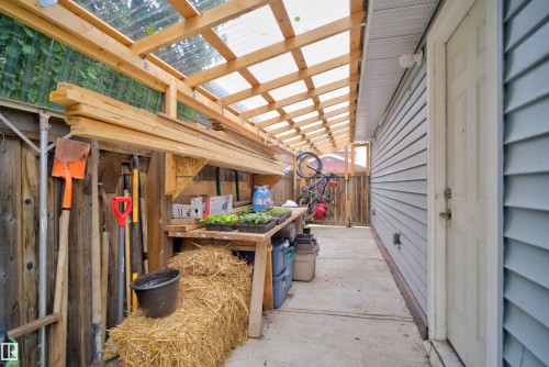 Covered outdoor workspace featuring a translucent panel roof and wood framing - 6928 22 Avenue, Edmonton, AB 