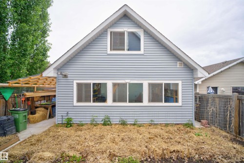 Rear exterior with light blue horizontal siding and white trim - 6928 22 Avenue, Edmonton, AB 