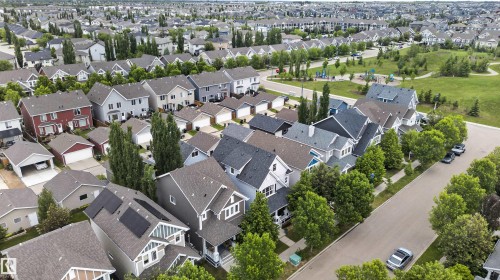 Residential neighborhood featuring a variety of single-family homes with pitched roofs and attached garages - 6928 22 Avenue, Edmonton, AB 