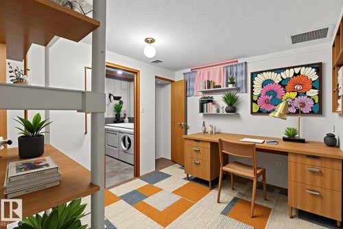 Dedicated office space featuring built-in wood-finish shelving and a coordinating wood-finish desk - 178 Tudor Lane, Edmonton, AB 