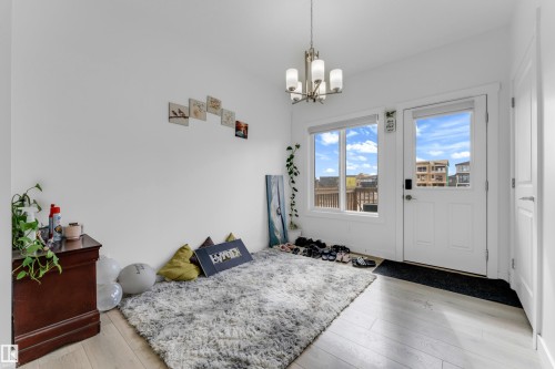 White-paneled exterior door with frosted glass and a keypad entry system - 432 29 Street, Edmonton, AB 