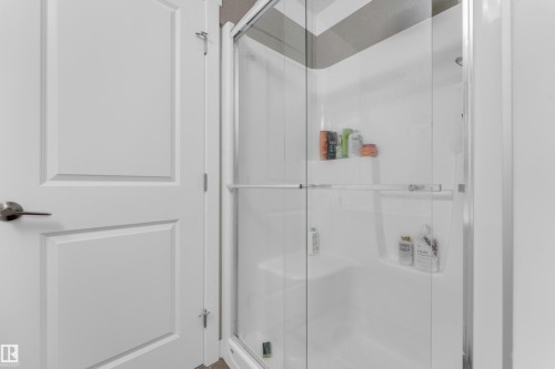 Shower enclosure with clear glass doors and a built-in bench - 432 29 Street, Edmonton, AB 