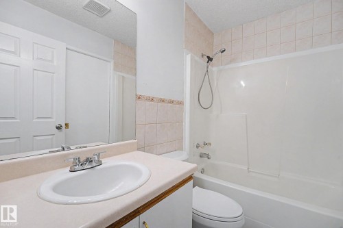 Bathroom vanity with an integrated sink and chrome faucet - 3704 39 Avenue, Edmonton, AB 