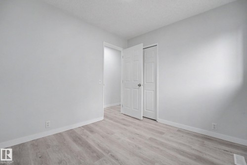 Room featuring light wood-finish flooring, white baseboards, and neutral wall paint - 3704 39 Avenue, Edmonton, AB 