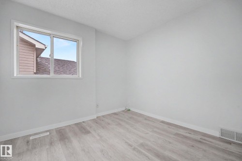 Light-toned wood-finish flooring complements white walls - 3704 39 Avenue, Edmonton, AB 