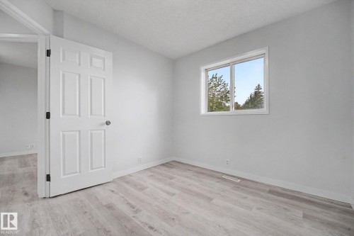 Light grey painted walls with white trim and wood-finish flooring - 3704 39 Avenue, Edmonton, AB 