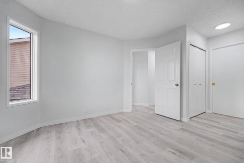 Room featuring light wood-finish flooring, white walls, and a single window - 3704 39 Avenue, Edmonton, AB 