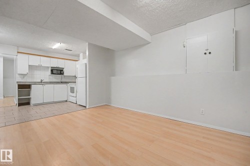 Open-concept living area with wood-finish flooring - 3704 39 Avenue, Edmonton, AB 