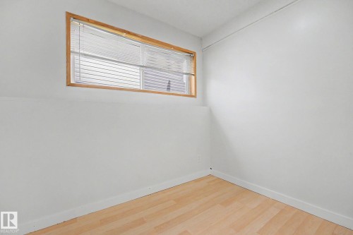 Room featuring light wood-finish flooring and white painted walls - 3704 39 Avenue, Edmonton, AB 