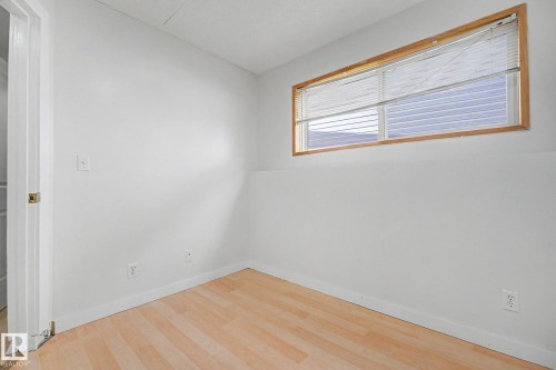 Light-toned wood-finish flooring complements the neutral wall color - 3704 39 Avenue, Edmonton, AB 