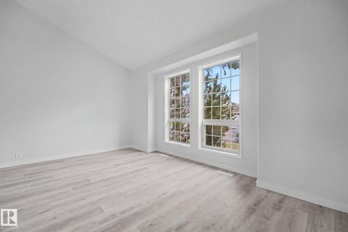 Bright interior space featuring a vaulted ceiling and light wood-finish flooring - 3704 39 Avenue, Edmonton, AB 