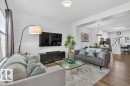 Open-concept living area featuring wood-finish flooring, recessed lighting, and a white color palette - 3708 42 Avenue, Beaumont, AB 