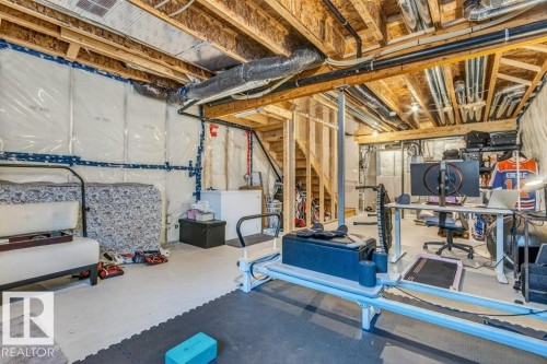 Unfinished lower level featuring exposed wood joists, visible ductwork, framed wall studs, and insulation - 3708 42 Avenue, Beaumont, AB 