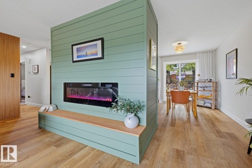 Feature wall with shiplap-style paneling and an integrated fireplace - 3504 102 Avenue, Edmonton, AB 
