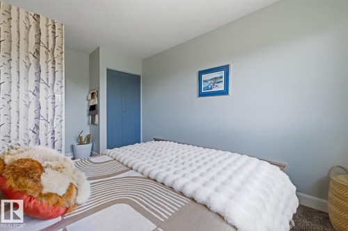 Neutral wall paint throughout, complemented by a feature wall with a birch tree pattern - 3504 102 Avenue, Edmonton, AB 