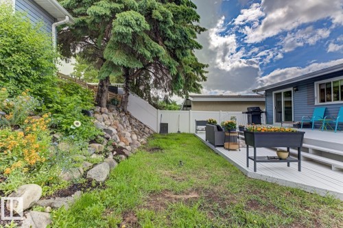 Spacious rear deck with light gray wood-finish flooring - 3504 102 Avenue, Edmonton, AB 