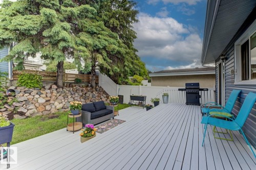 Expansive outdoor deck featuring light-colored wood-finish flooring - 3504 102 Avenue, Edmonton, AB 