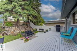 Expansive outdoor deck featuring light-colored wood-finish flooring - 