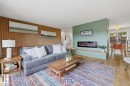 Living area featuring a floor-to-ceiling accent wall with wood paneling - 3504 102 Avenue, Edmonton, AB 