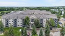 Multi-story residential building with private balconies and a neutral-toned exterior - 122 279 Suder Greens Drive, Edmonton, AB 