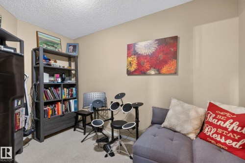 Neutral-toned walls complement the textured ceiling - 122 279 Suder Greens Drive, Edmonton, AB 
